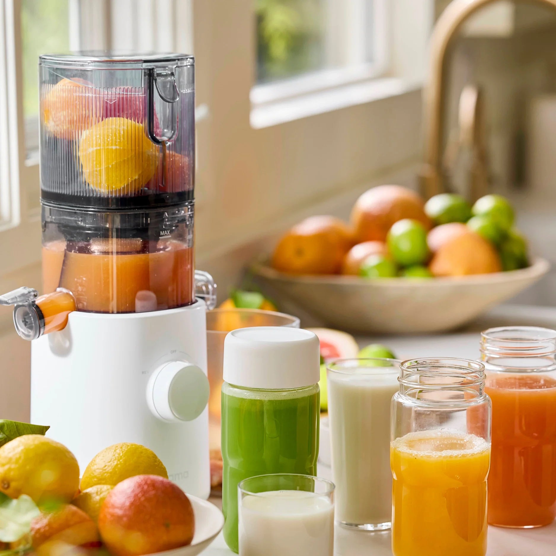 Nama J3 SJ300 compact cold-press auger juicer with its small hopper and juice and pulp collection setup