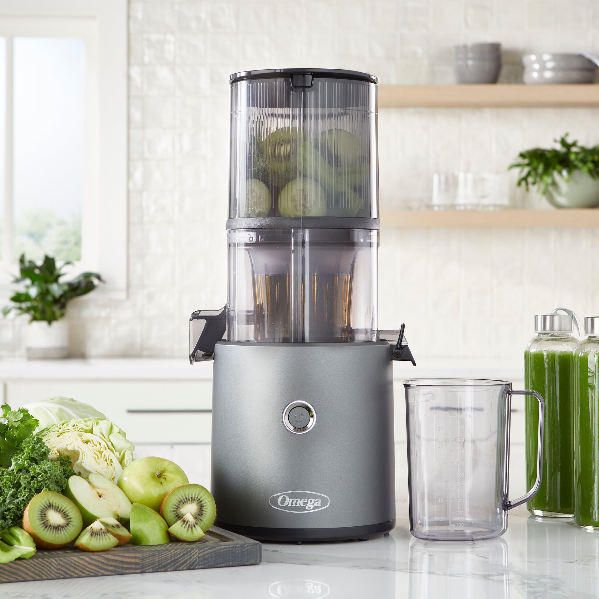 Gray Omega JC2022 Effortless Batch Juicer with its hopper, juice cup and pulp outlet
