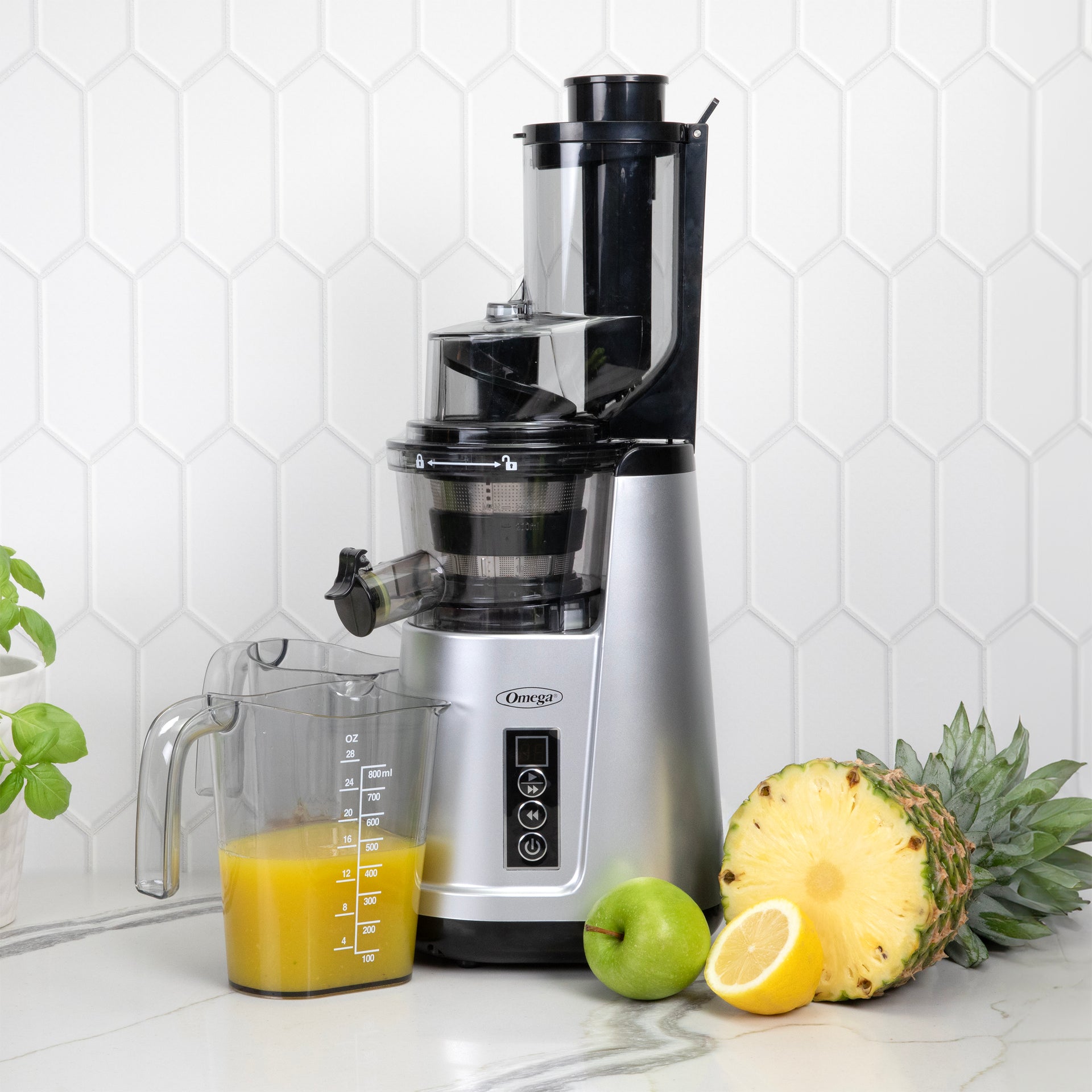 Silver Omega JC4000 vertical cold-press juicer with wide-mouth feed chute and marked juice container
